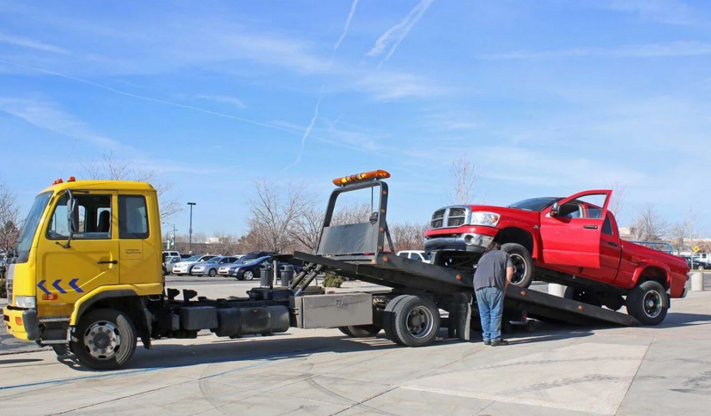 Professional towing truck loading a commercial ute
