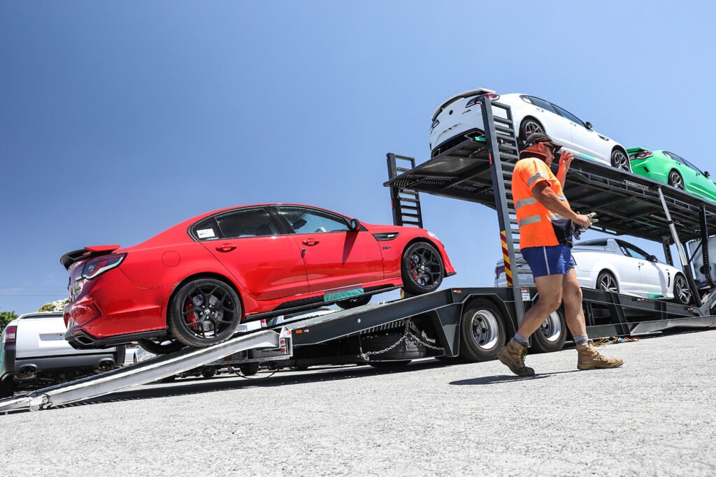 Professional towing truck loading a hybrid vehicle safely