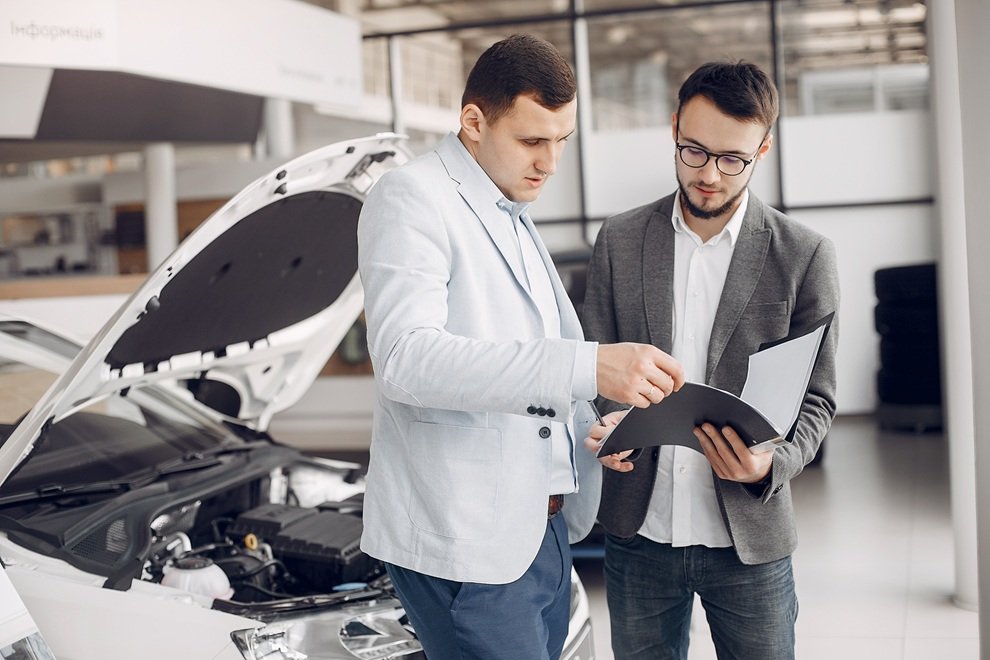 Professional auto buyer inspecting a good condition car safely