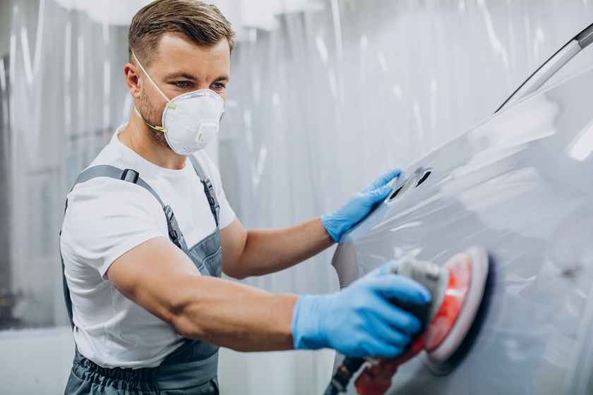 Professional detailer keeping car paint good condition safely