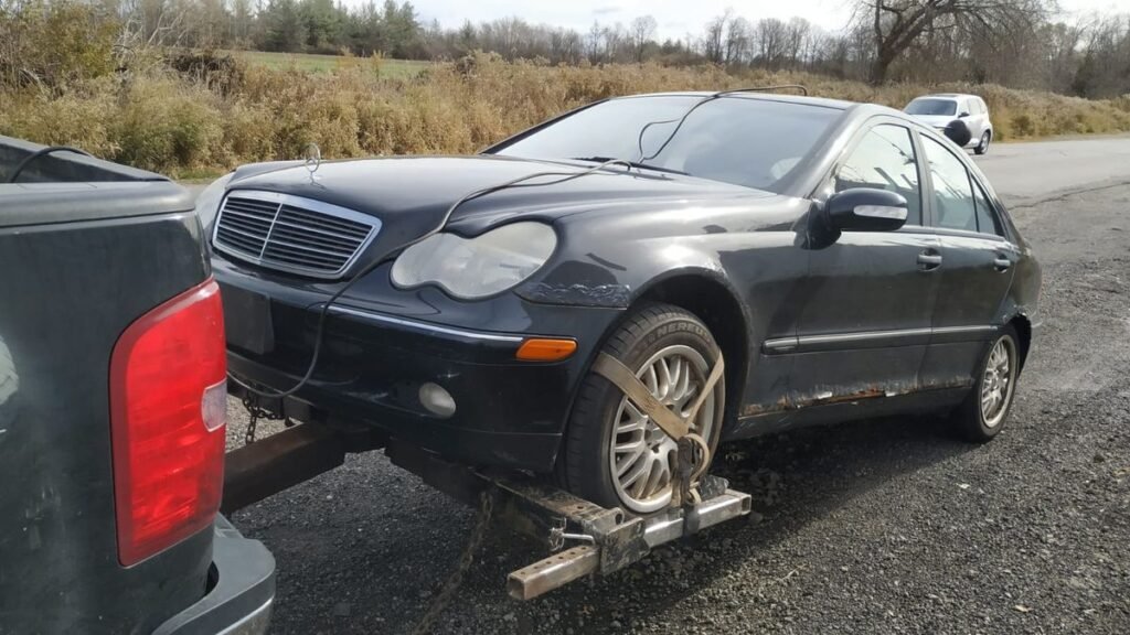 Professional tow truck extracting an old vehicle when selling a car that has been sitting for years