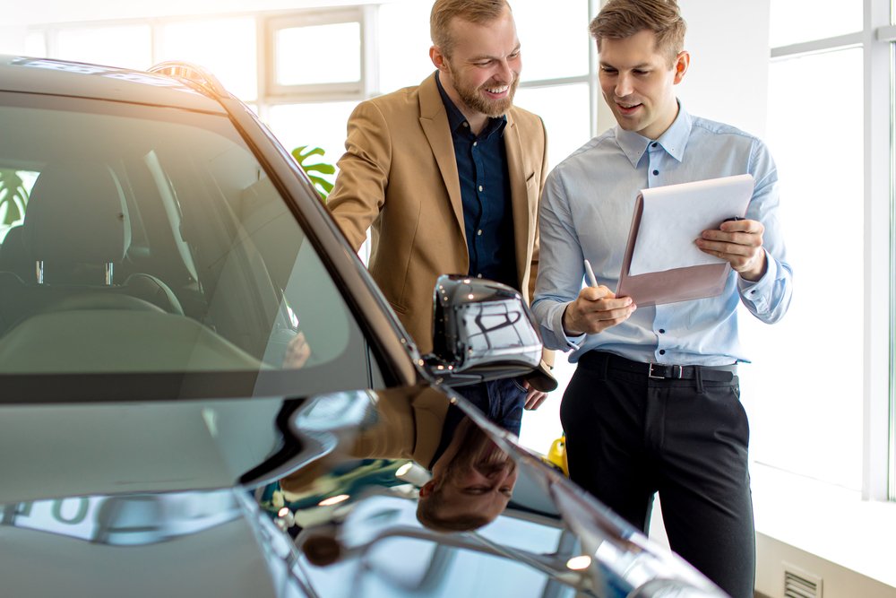 Seller handing keys to a buyer showing how to sell a car privately in victoria safely